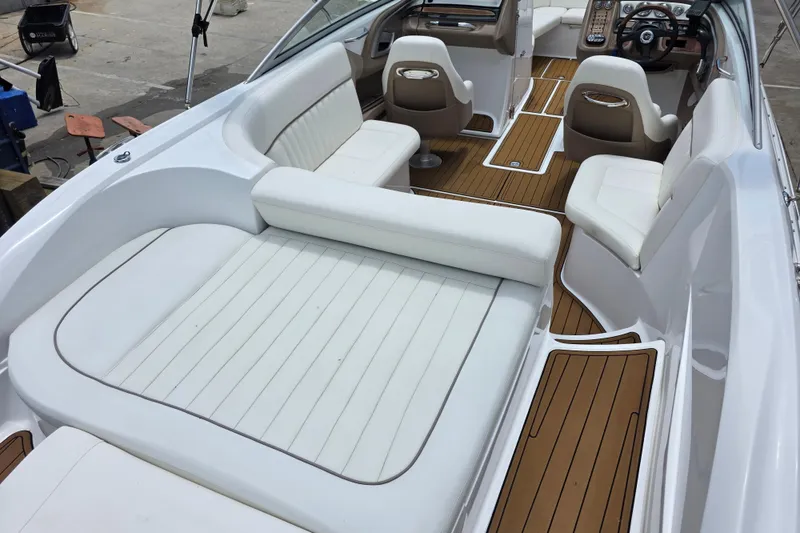 Slide: The Image of Luxurious interior of a 2006 Cobalt 272 boat with white seating and wood accents. - 7