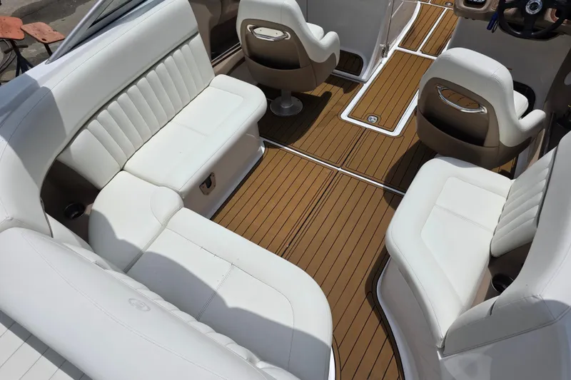 Slide: The Image of Interior of a 2006 Cobalt 272 boat with white seating and wooden flooring. - 9