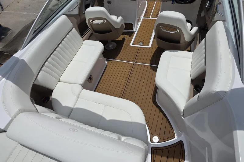 Slide: The Image of Luxurious interior of a 2006 Cobalt 272 boat with white seating and wood flooring. - 8