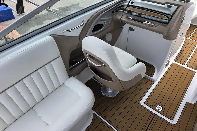 Slide: The Image of Interior of a 2006 Cobalt 272 boat with white seating and wood-style flooring. - 14