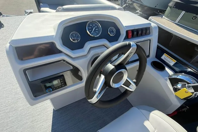 Slide: The Image of Steering console of 2027 Godfrey EX 2286 SFLX boat with modern controls and gauges. - 10