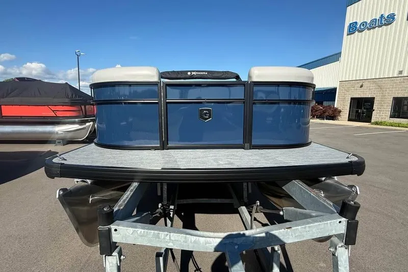 Slide: The Image of 2027 Godfrey EX 2286 SFLX pontoon boat on trailer, parked outside dealership. - 1