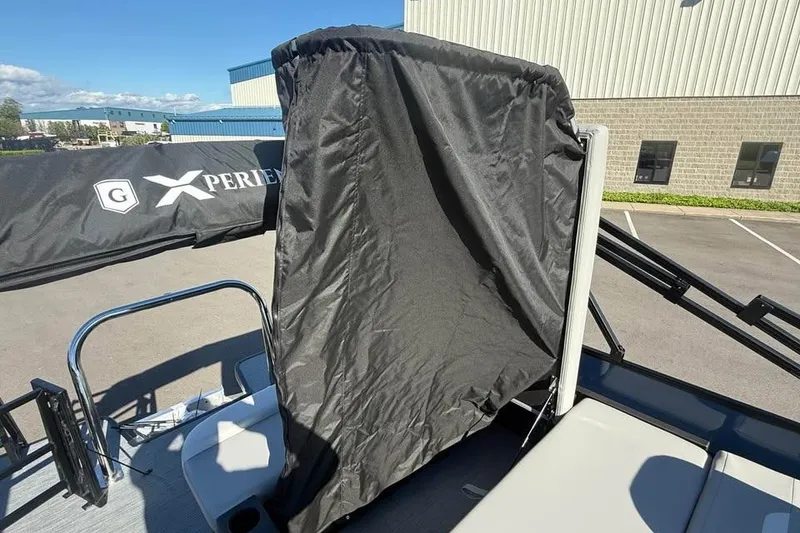 Slide: The Image of 2027 Godfrey EX 2286 SFLX boat with protective cover in a parking lot. - 14