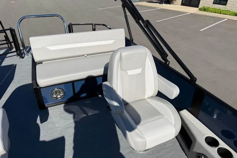 Slide: The Image of 2027 Godfrey EX 2286 SFLX boat interior with white seating and cup holders. - 9