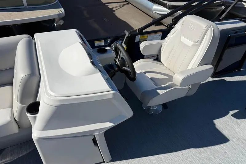 Slide: The Image of Captain's chair and console of 2027 Godfrey EX 2286 SFLX boat, featuring sleek design. - 8