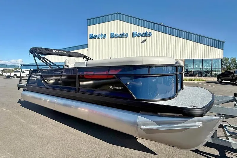The Image of 2027 Godfrey EX 2286 SFLX pontoon boat displayed outside dealership. - 0