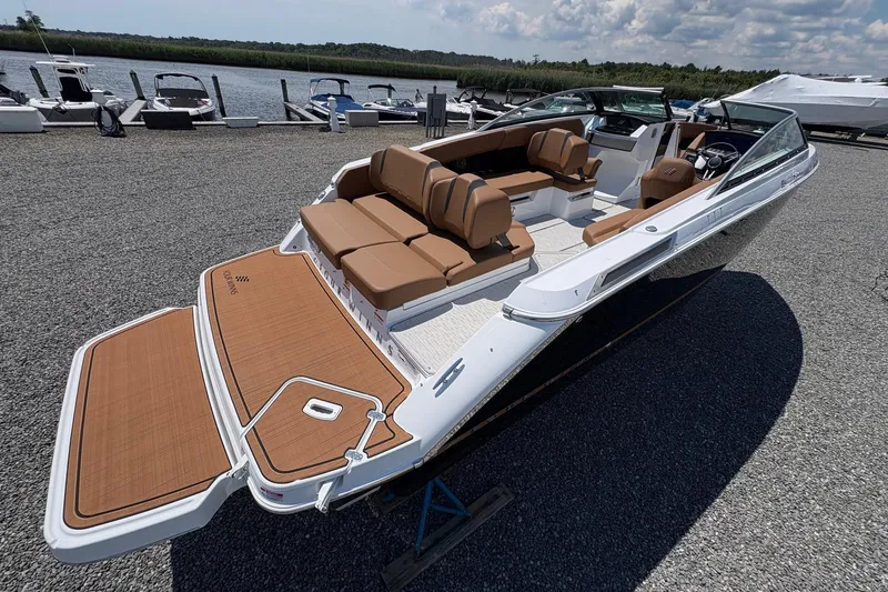 Slide: The Image of 2026 Four Winns H6 boat with spacious seating, docked near a serene waterfront. - 7