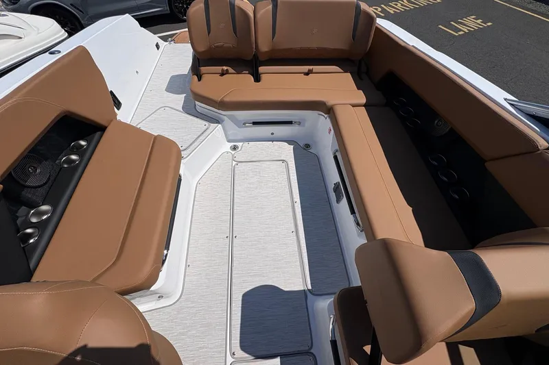 Slide: The Image of Interior of 2026 Four Winns H6 boat with tan seating and modern design. - 11