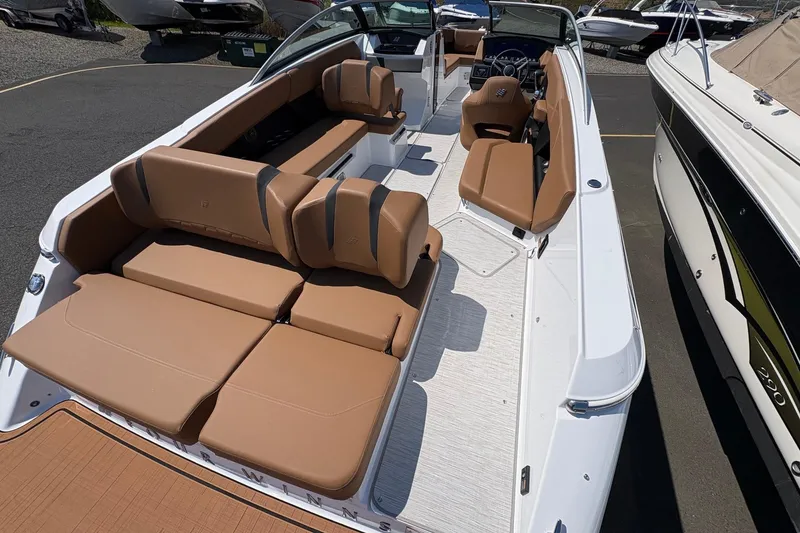 Slide: The Image of 2026 Four Winns H6 boat with spacious tan seating and sleek white interior design. - 8