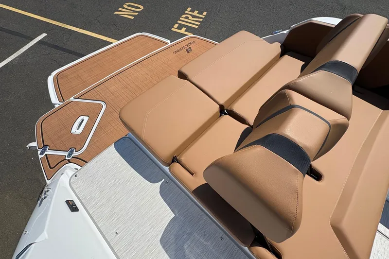 Slide: The Image of 2026 Four Winns H6 boat with tan leather seating and teak-style deck. - 9