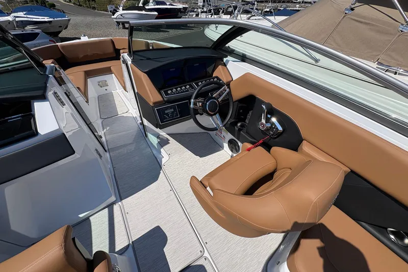 Slide: The Image of Interior view of 2026 Four Winns H6 boat with modern dashboard and tan seating. - 12