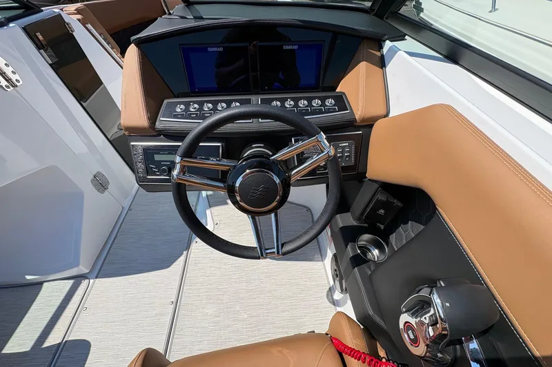 Slide: The Image of 2026 Four Winns H6 boat cockpit with modern steering wheel and control panel. - 13