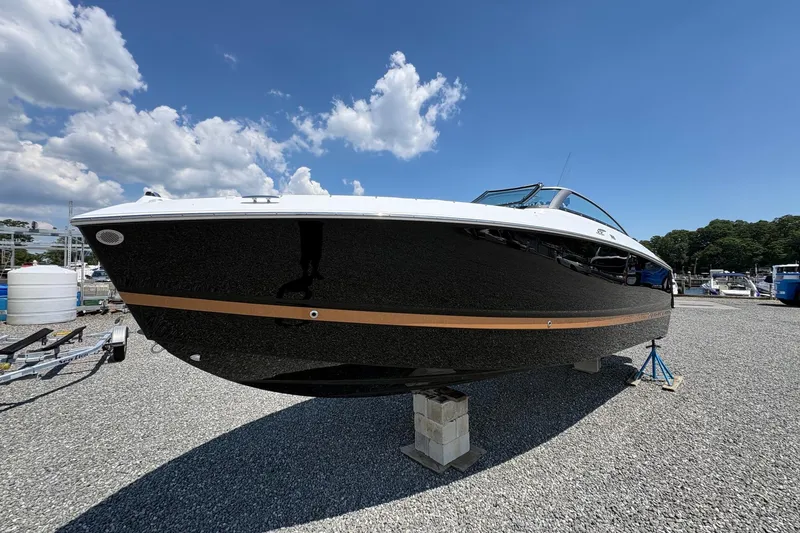 Slide: The Image of 2026 Four Winns H6 boat on display under a clear blue sky. - 1