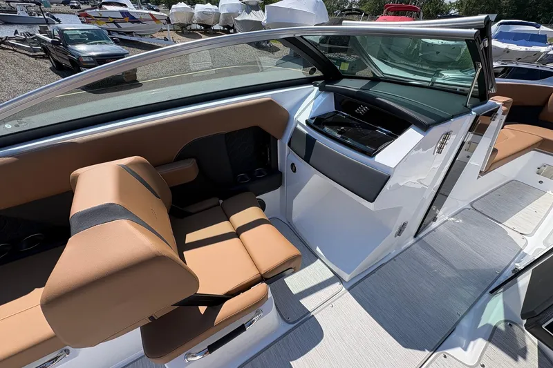 Slide: The Image of Interior of 2026 Four Winns H6 boat with tan seating and sleek design. - 14