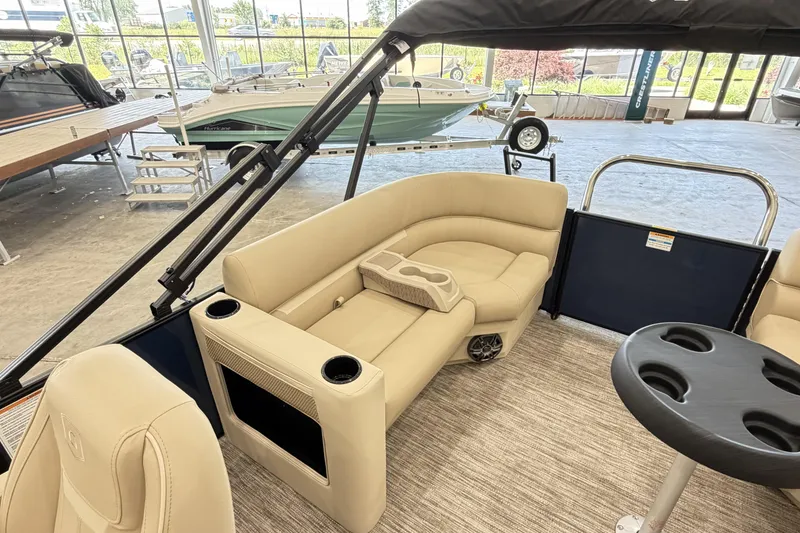 Slide: The Image of Luxurious interior of 2027 Godfrey EX 2286 SBX pontoon boat with beige seating and cup holders. - 10