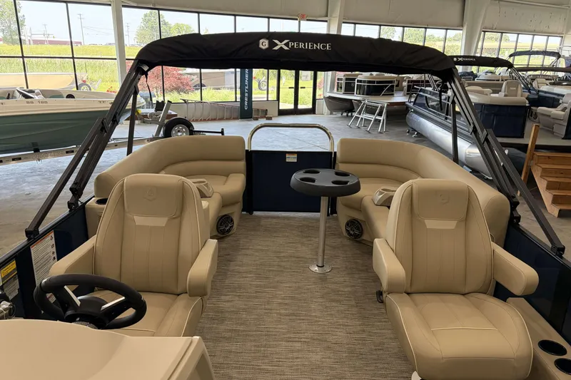 Slide: The Image of 2027 Godfrey EX 2286 SBX pontoon boat interior with beige seating and steering wheel. - 6