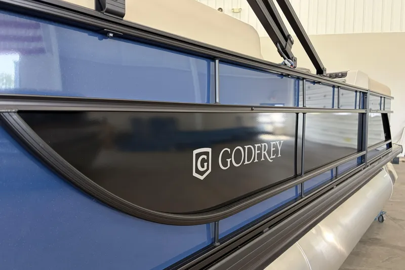 Slide: The Image of 2027 Godfrey EX 2286 SBX pontoon boat with sleek blue and black design. - 11