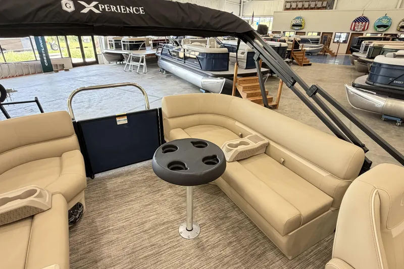 Slide: The Image of Interior of 2027 Godfrey EX 2286 SBX pontoon boat with beige seating and cup holders. - 9