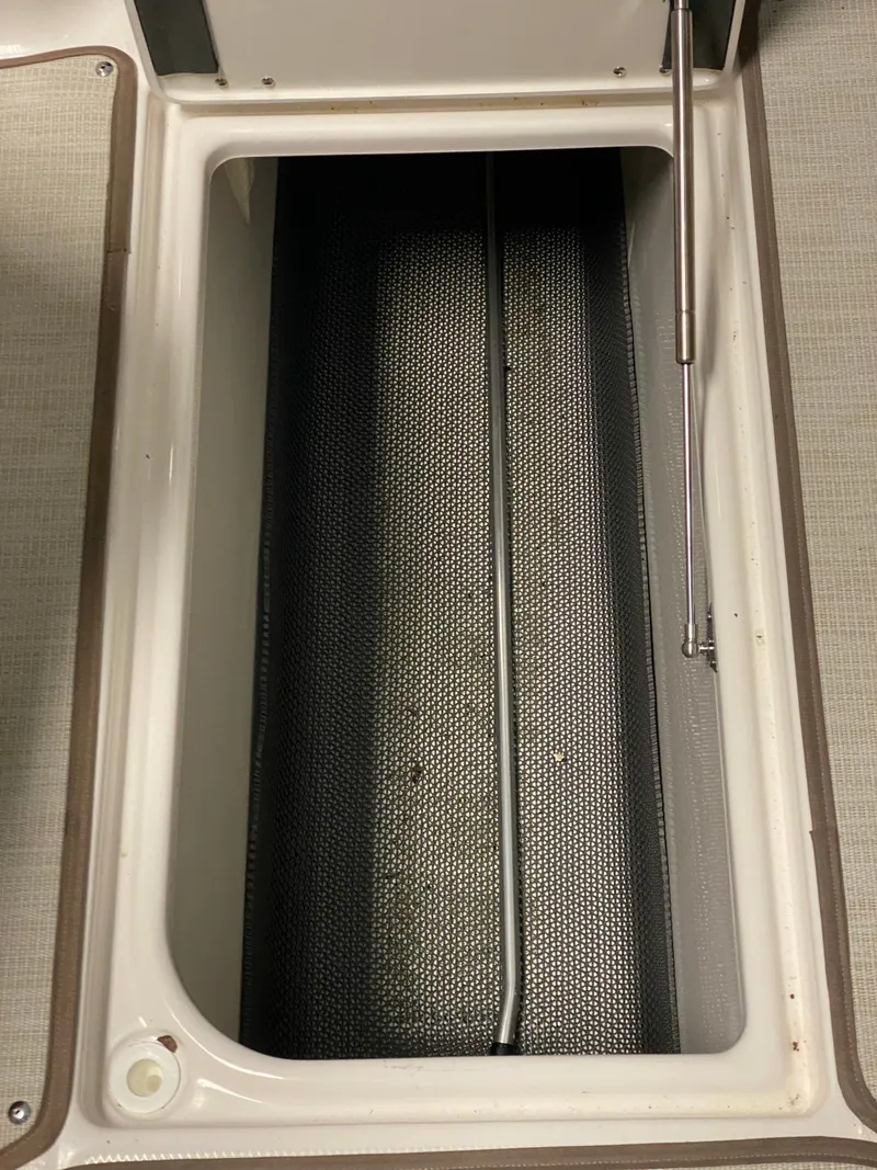 Slide: The Image of An open storage compartment on a boat with a hydraulic lift arm. - 28
