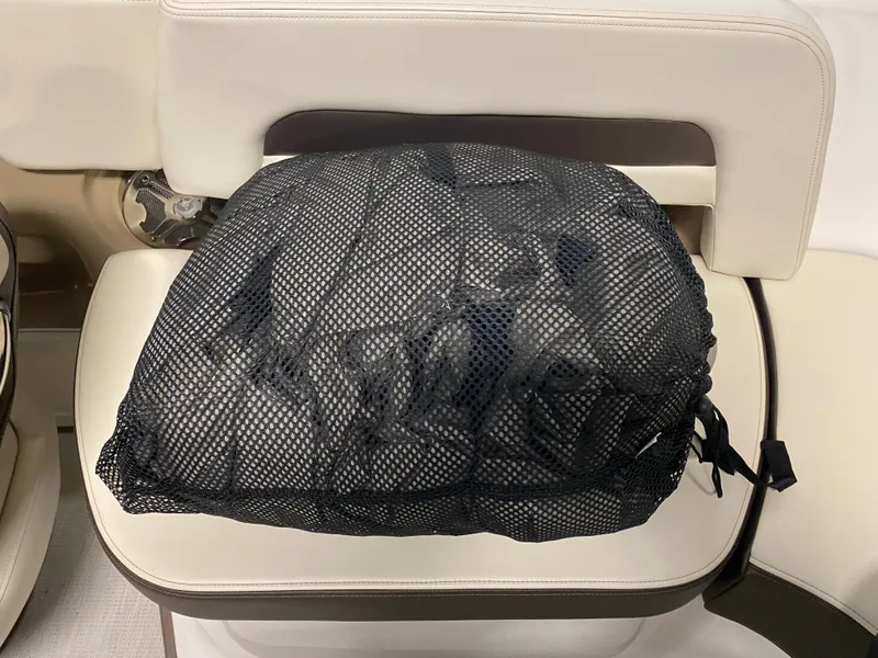 Slide: The Image of A mesh bag sits on a white boat seat. - 26