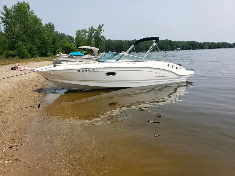Slide: The Image of 2020 Chaparral 24 SSI on a sandy shore of a calm lake. - 1