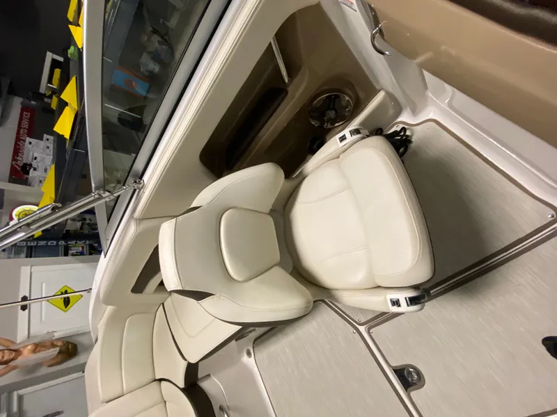 Slide: The Image of Interior view of a Chaparral 24 SSI boat with beige leather seats and a modern design. - 19