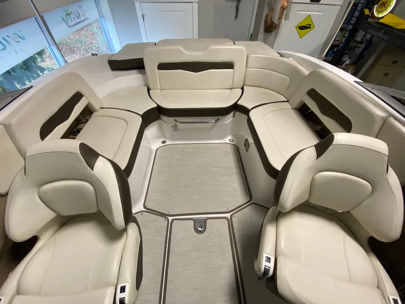 Slide: The Image of Interior view of a 2020 Chaparral 24 SSI boat with beige upholstered seating. - 14