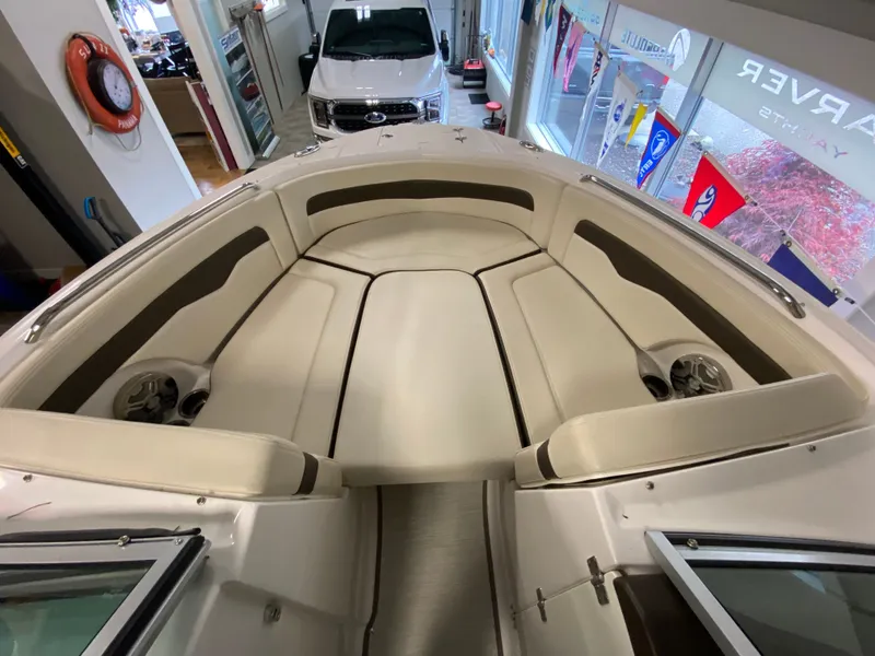 Slide: The Image of The image shows the bow area of a Chaparral 24 SSI boat with beige upholstery. - 6