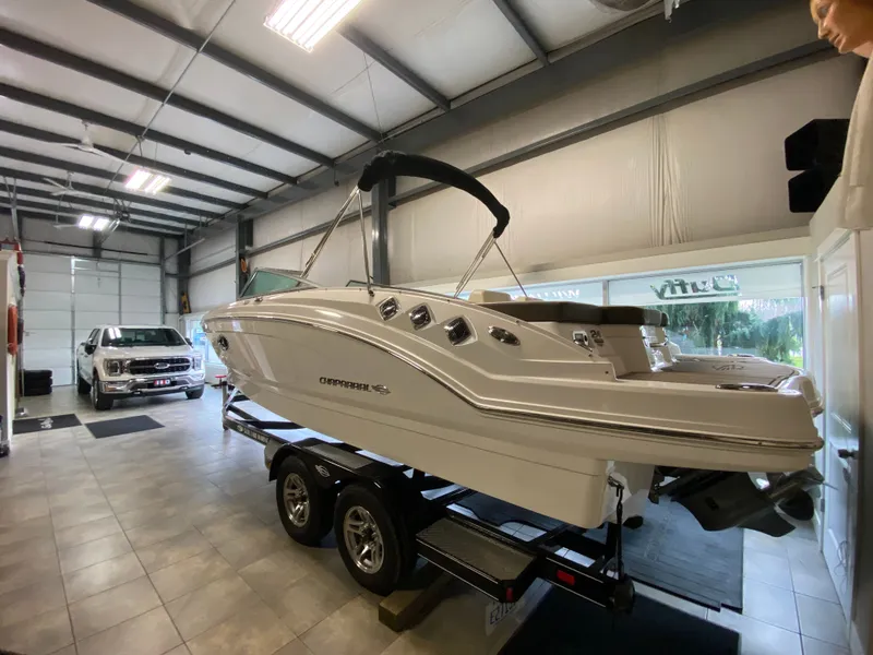 Slide: The Image of A 2020 Chaparral 24 SSI boat on a trailer inside a garage. - 9