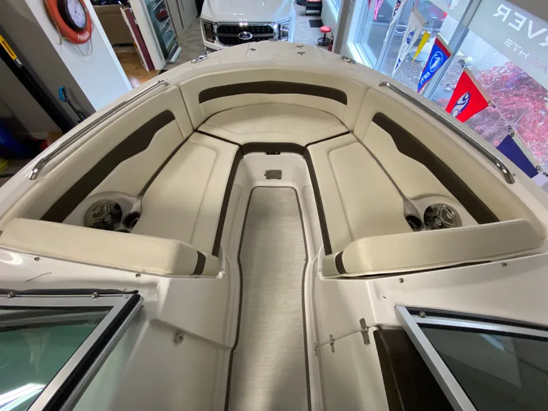 Slide: The Image of Interior view of a Chaparral 24 SSI boat with beige seating and speakers. - 18