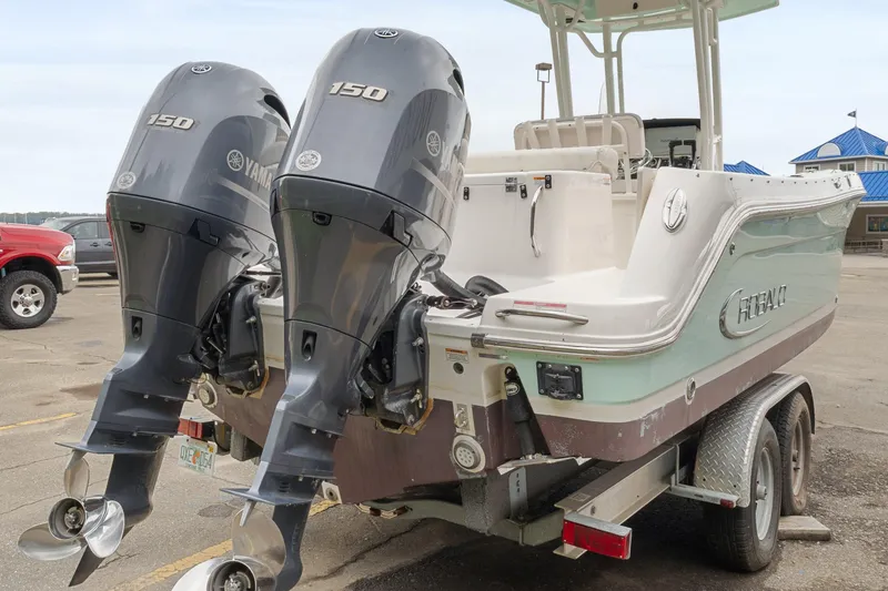 Slide: The Image of 2017 Robalo R242 Center Console boat with twin Yamaha 150 engines on a trailer. - 38