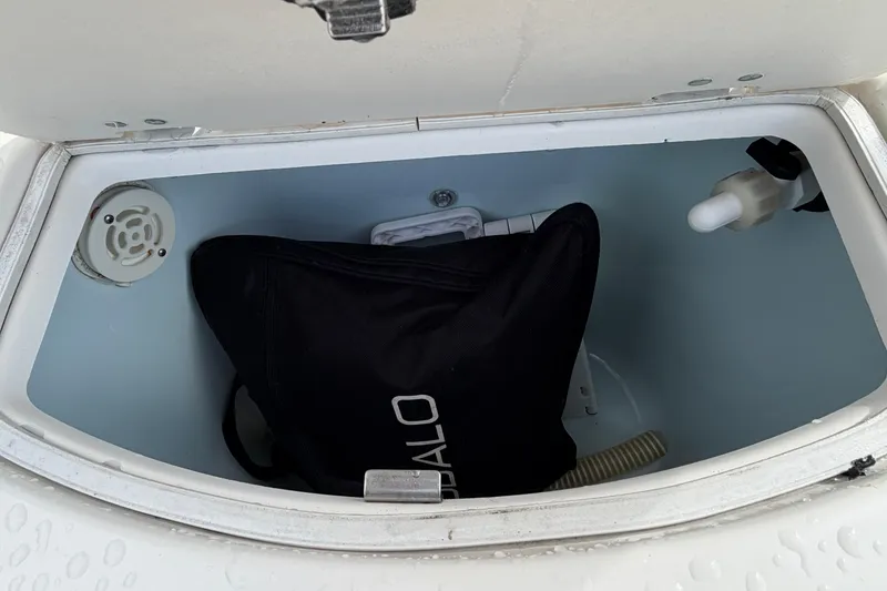 Slide: The Image of Storage compartment of 2017 Robalo R242 Center Console boat with black bag inside. - 54