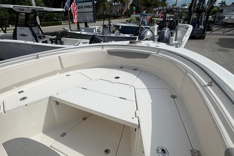 Slide: The Image of 2017 Robalo R242 Center Console boat interior with seating and storage compartments. - 29
