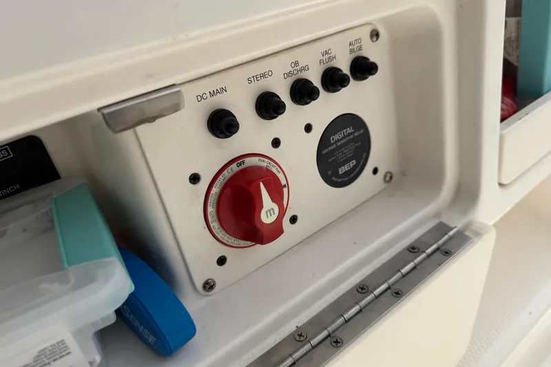Slide: The Image of Control panel of a 2017 Robalo R242 Center Console boat with switches and a red dial. - 70