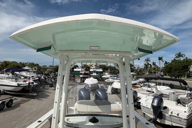 Slide: The Image of 2017 Robalo R242 Center Console boat in a marina with other vessels. - 24