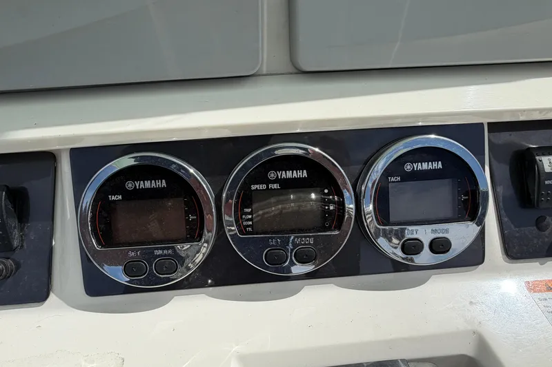 Slide: The Image of Yamaha gauges on 2017 Robalo R242 Center Console boat dashboard. - 19
