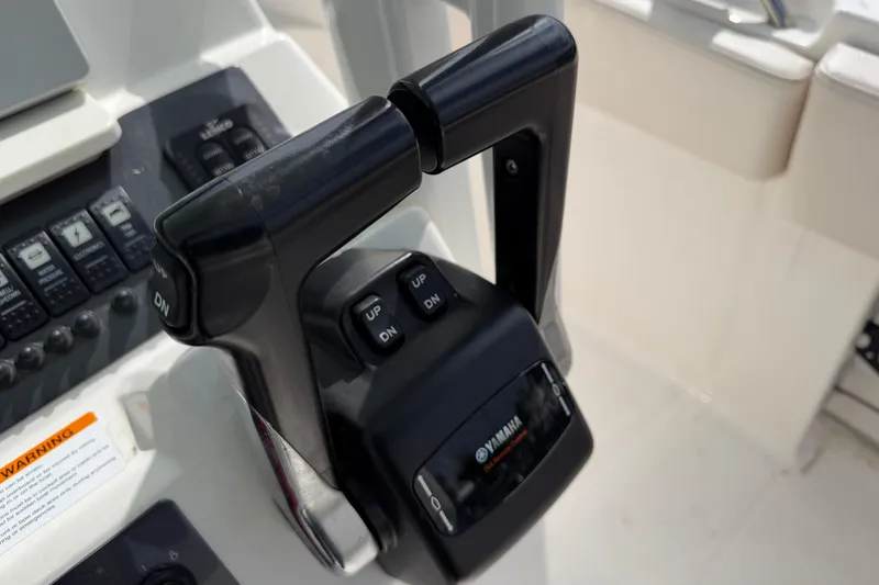 Slide: The Image of Throttle controls on a 2017 Robalo R242 Center Console boat. - 59