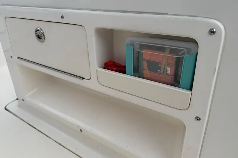 Slide: The Image of Storage compartment on a 2017 Robalo R242 Center Console boat. - 66