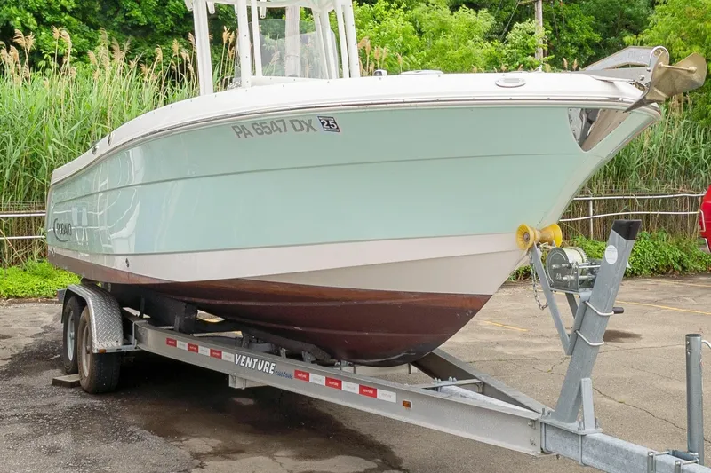 Slide: The Image of 2017 Robalo R242 Center Console boat on trailer, parked outdoors. - 9