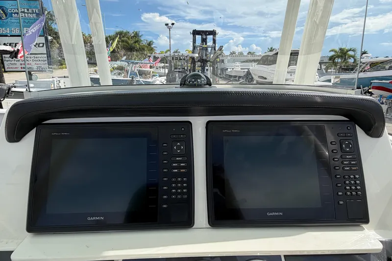 Slide: The Image of Dual Garmin displays on 2017 Robalo R242 Center Console boat dashboard. - 23