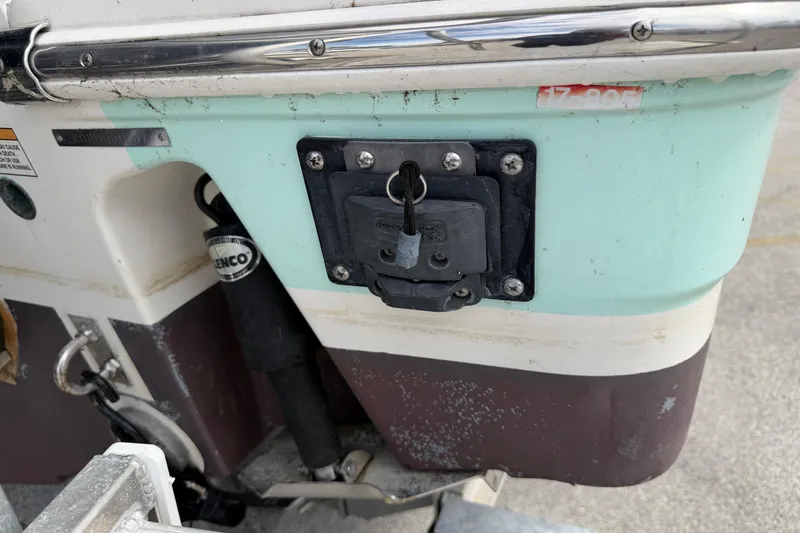Slide: The Image of 2017 Robalo R242 Center Console boat stern with Lenco trim tab and key slot. - 49
