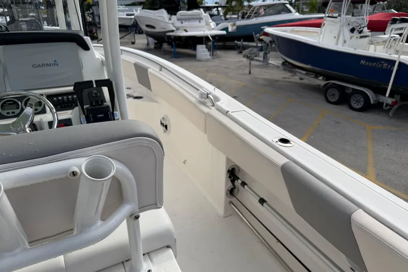 Slide: The Image of 2017 Robalo R242 Center Console boat interior with Garmin equipment, docked among other boats. - 15