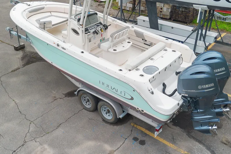 Slide: The Image of 2017 Robalo R242 Center Console boat with dual Yamaha engines on a trailer. - 43