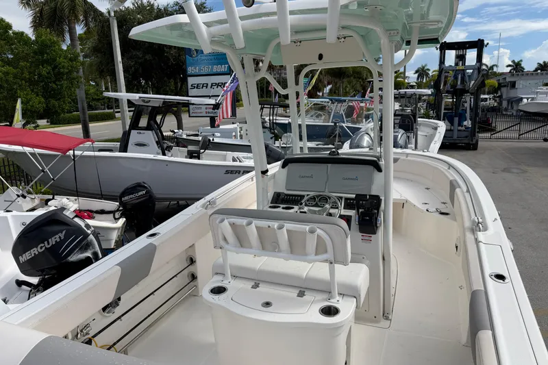 Slide: The Image of 2017 Robalo R242 Center Console boat with Mercury engines, docked at a marina. - 14