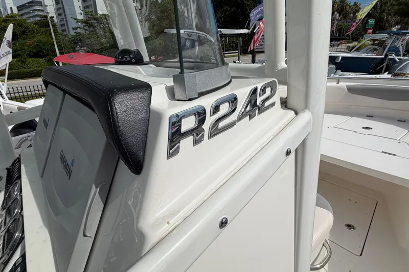 Slide: The Image of 2017 Robalo R242 Center Console boat with Garmin electronics, docked outdoors. - 27