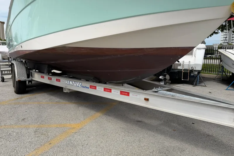 Slide: The Image of 2017 Robalo R242 Center Console boat on Venture trailer in parking lot. - 46