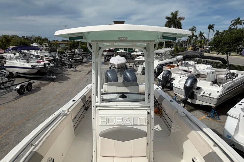 Slide: The Image of 2017 Robalo R242 Center Console boat in a marina with other vessels. - 26
