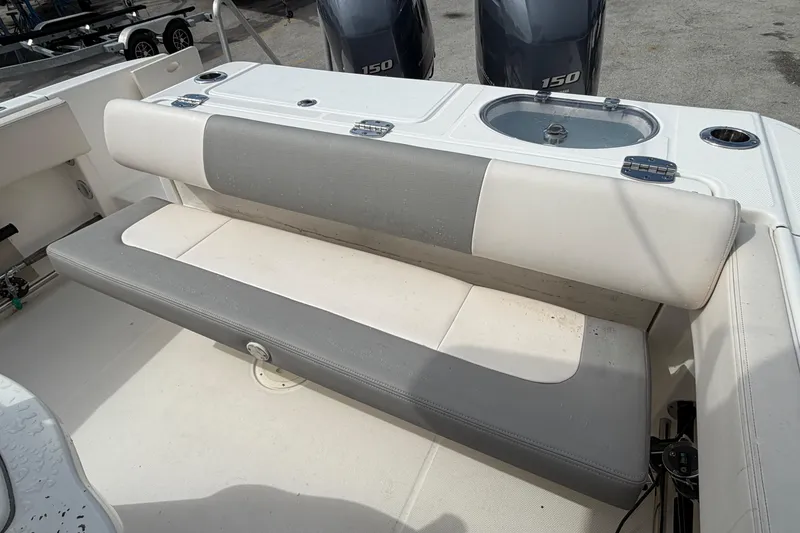 Slide: The Image of 2017 Robalo R242 Center Console boat with cushioned seating and dual 150 engines. - 37