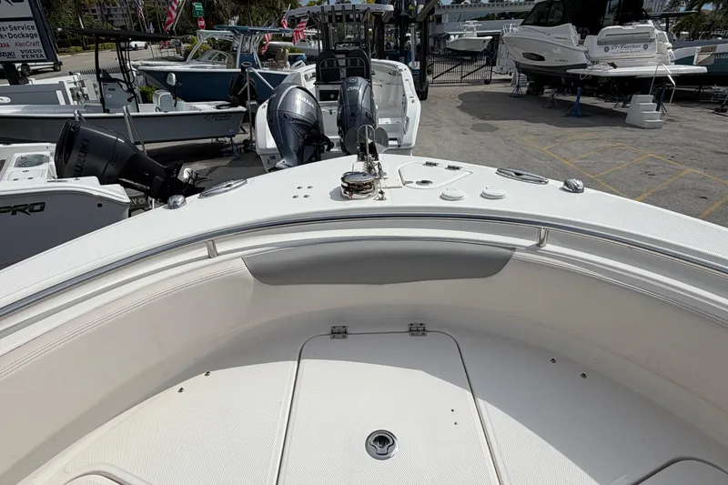Slide: The Image of 2017 Robalo R242 Center Console boat interior with dual engines, docked at marina. - 56