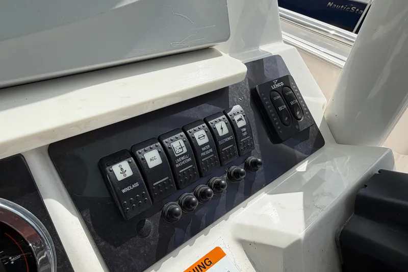 Slide: The Image of Control panel of a 2017 Robalo R242 Center Console boat with labeled switches. - 20